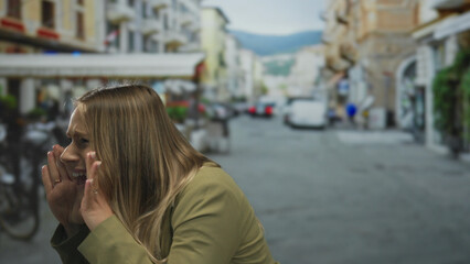 Woman shouting outdoors on a bustling city street surrounded by bikes and buildings showcasing urban life.