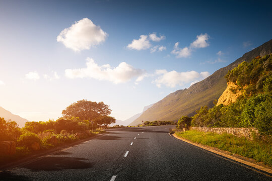 Scenic road along Ocean and Mountains at sunset. Chapman&rsquo;s Peak Drive.
