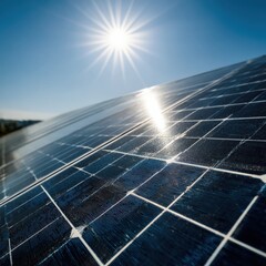 Closeup of solar panels on a rooftop under a bright blue sky with the sun shining intensely, highlighting renewable energy technology