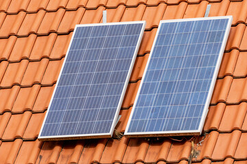 Photovoltaic cells converting sunlight into electricity on a roof, symbolizing sustainable energy and eco friendly living