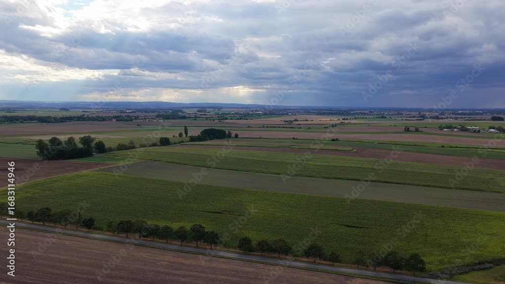Wall mural czech landscape of fields and meadows from a drone view. cloudy sky with clouds and villages in the 