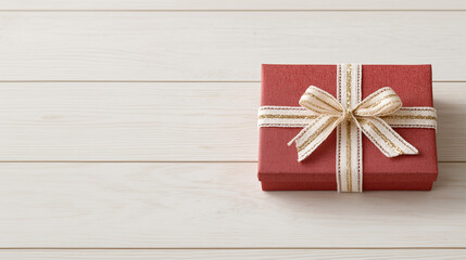 Fototapeta premium red gift box wrapped in a striped bow on top of a wood table