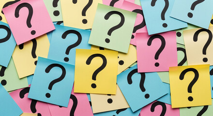 Colorful sticky notes with question marks, overlapping to create a textured background, symbolizing uncertainty, inquiry, and problem-solving