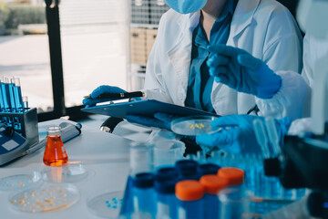 Fototapeta premium Collaboration, tablet or science with people in lab together for research or development. Innovation, tech and microscope with scientist team in clinical trial for planning or medical investigation