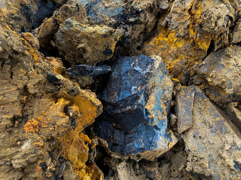 Close-up texture of rough soil and minerals at a mining or construction site.