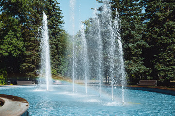 city fountain in the center of Stavropol with a rainbow on the water jets. Sunny day, freshness and...