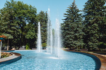 city fountain in the center of Stavropol with a rainbow on the water jets. Sunny day, freshness and positive in the city atmosphere. Ideal for themes: nature, city life, recreation, tourism, ecology