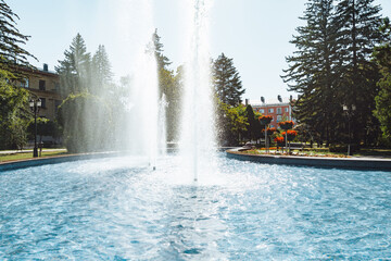 city fountain in the center of Stavropol with a rainbow on the water jets. Sunny day, freshness and...