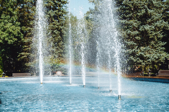 city fountain in the center of Stavropol with a rainbow on the water jets. Sunny day, freshness and positive in the city atmosphere. Ideal for themes: nature, city life, recreation, tourism, ecology