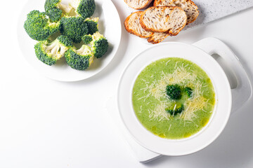 Warm and comforting creamy broccoli soup served in a bowl, garnished with parmesan cheese and croutons.