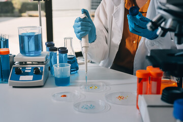 Fototapeta premium Collaboration, tablet or science with people in lab together for research or development. Innovation, tech and microscope with scientist team in clinical trial for planning or medical investigation