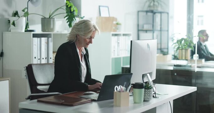 Computer, thinking and mature businesswoman typing email, environmental policy or research. Laptop, sustainability manager and reading in office for green project, planning or idea for csr insight