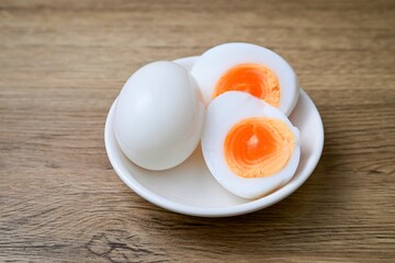 Medium-boiled egg,Boiled egg in white plate on wooden background