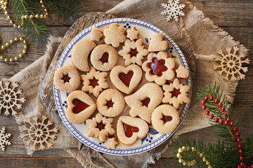 Linzer Christmas cookies filled with marmalade and dusted with sugar on a plate, top view