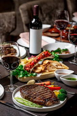 Dining table filled with gourmet dishes. A luxurious dining table showcases various gourmet dishes, including grilled steak, vibrant vegetables, and fine wine.