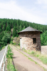 A powerful series capturing the industrial beauty of a hydroelectric dam, from its rustic stone building to the detailed concrete spillway. An impressive display of engineering blending with nature.