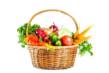 Fresh shiny different vegetables in a wicker basket. Isolated on white background.