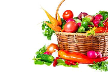 Fresh shiny different vegetables in a wicker basket. Isolated on white background.