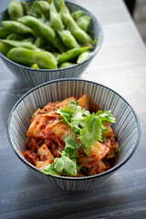 Kim chi with herbs top view on table.