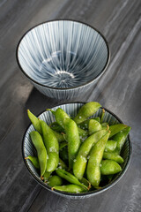 Plate with green edamame with salt.