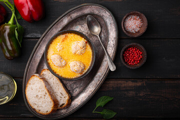 Soup with meatballs, potatoes and cheese. Meatballs in thick vegetable soup Albondigas. Mexican and Spanish, European and Russian cuisine. Black wooden background