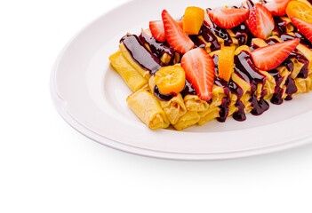 Delicious crepes topped with fresh fruit and rich sauce for dessert
