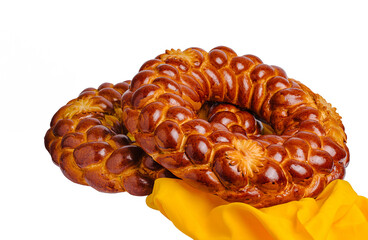 Freshly baked traditional bread rings on a bright yellow cloth