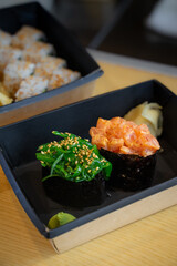 Gunkan sushi with seaweed and with salmon.