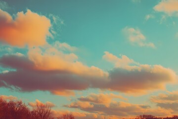 Fototapeta premium Colorful clouds fill the sky at sunset over a tranquil landscape in autumn