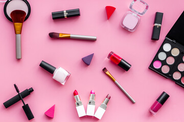 Flatlay of makeup cosmetics on pink background. Blusher, mascara and lipstick, top view