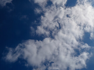 Fluffy white clouds against a deep blue sky.
