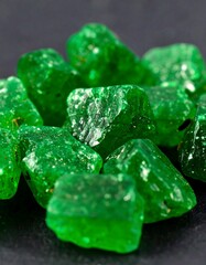 Close-up of many small, vibrant green gemstones