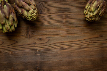 Whole heads of purple artichokes top view. Vegetables food ready to cook