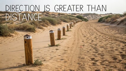 Sandy pathway with wooden markers at the dunes highlighting direction over distance