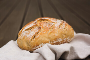 Loaf of sourdough bread on linen cloth