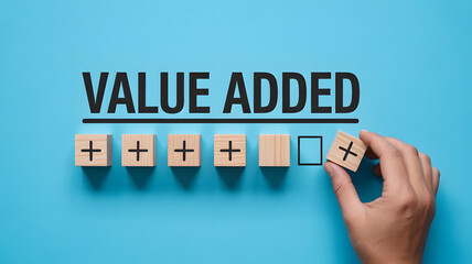 Adding value concept visualized with plus signs on wooden blocks and hand
