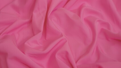 Obraz premium Vibrant pink fabric with soft folds and gentle texture