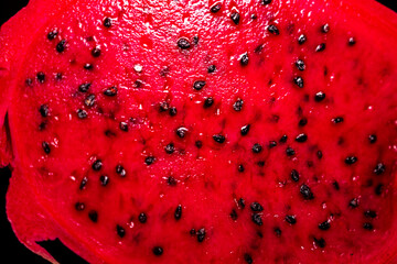 Close-up view of a sliced watermelon showcasing its vibrant red flesh and numerous black seeds, highlighting the juicy texture and natural patterns. neutral background, clear negative space, clean