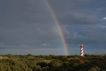 lighthouse with rainbow after rain and storm