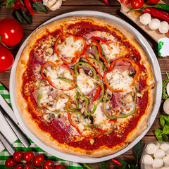 Pizza with quattro staggioni, mozzarella and tomato sauce. Pizza wooden table