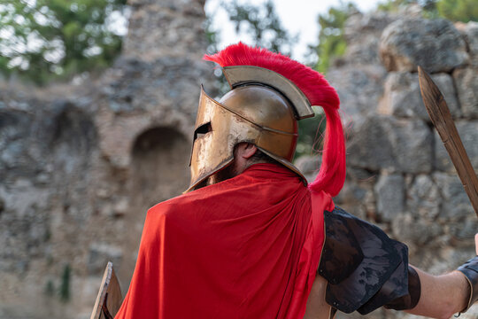 Greek Spartan warrior in front of the ruins of the ancient city of Sparta, Greece
