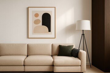 Beige living room interior with framed modern abstract artwork, beige sofa, and floor lamp in minimalist style.