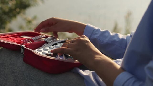 First aid kit. Woman and first aid kit. by the pond. Slow motion. High quality video in 4K format.