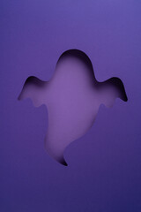 Purple vertical  background showcasing a ghost-shaped cutout design, evoking seasonal vibes and creativity