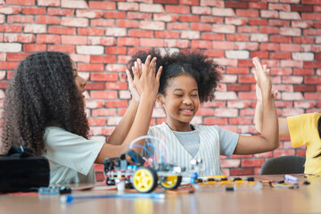 Young Girls Engaged in Robotics and STEM Learning, Diverse Kids Building a Robot Arm in a Science Workshop, Girls Exploring Technology and Innovation