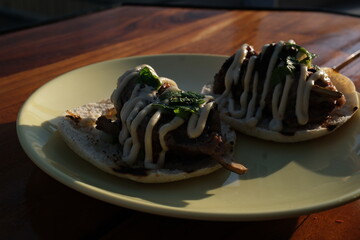 Tacos plate sauce Traditional mexican food. Shrimp tacos with melted cheese and poblano pepper called gobernador on wooden background.