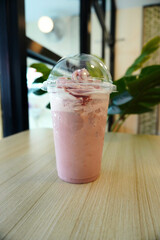 Fresh creamy milkshake served on cafe table with natural light, modern interior background, refreshing beverage concept for lifestyle dining