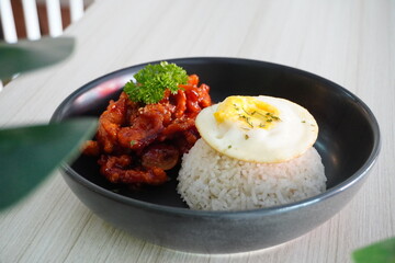 Delicious Fried Chicken with Rice and Fried Egg Served on Black Plate – Asian Cuisine Food Photography