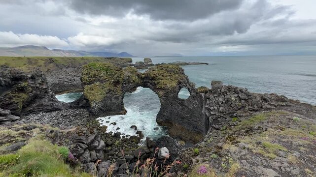 Cloudy view of rocky coastline in Arnarstapi, Iceland.