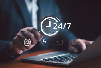 Businessman using laptop with 24/7 customer support icons including phone, email, chat, and internet communication symbol, representing online service, business technology, and digital assistance.